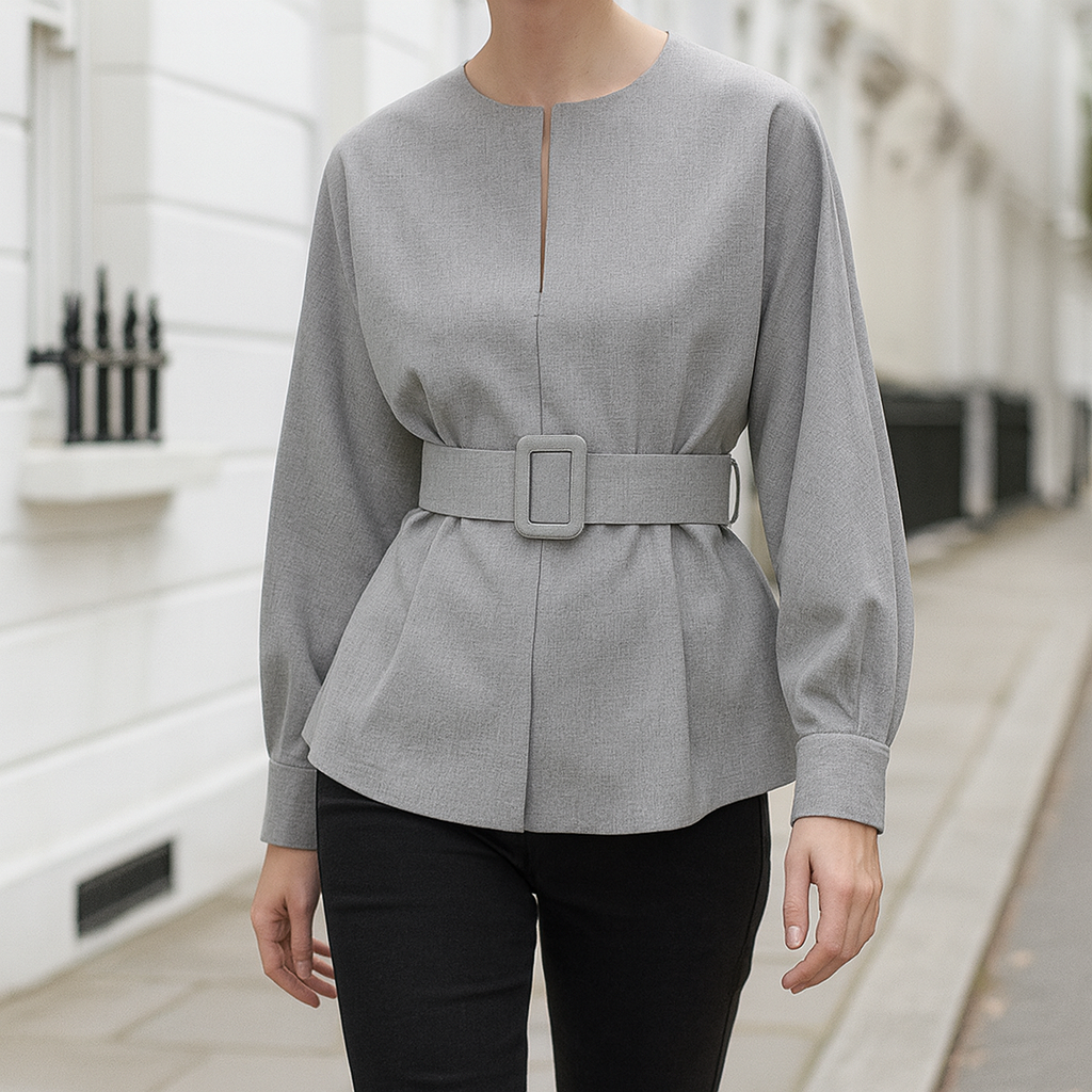 Long-sleeve blouse with a round neckline, front slit detail, belted waist, and wide cuffs.