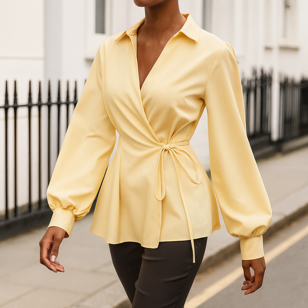 Long-sleeve wrap blouse with a collared neckline, tie closure at the waist, and gathered cuffs.