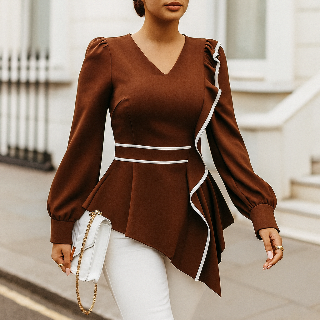 Long-sleeve blouse with a V-neckline, asymmetrical ruffle trim, fitted waist, and puffed cuffs.