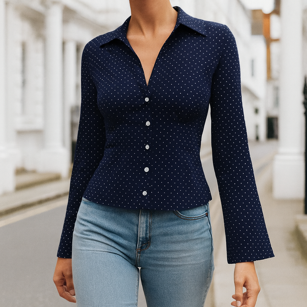 Long-sleeve fitted blouse with a collared neckline, button-down front, and flared cuffs.